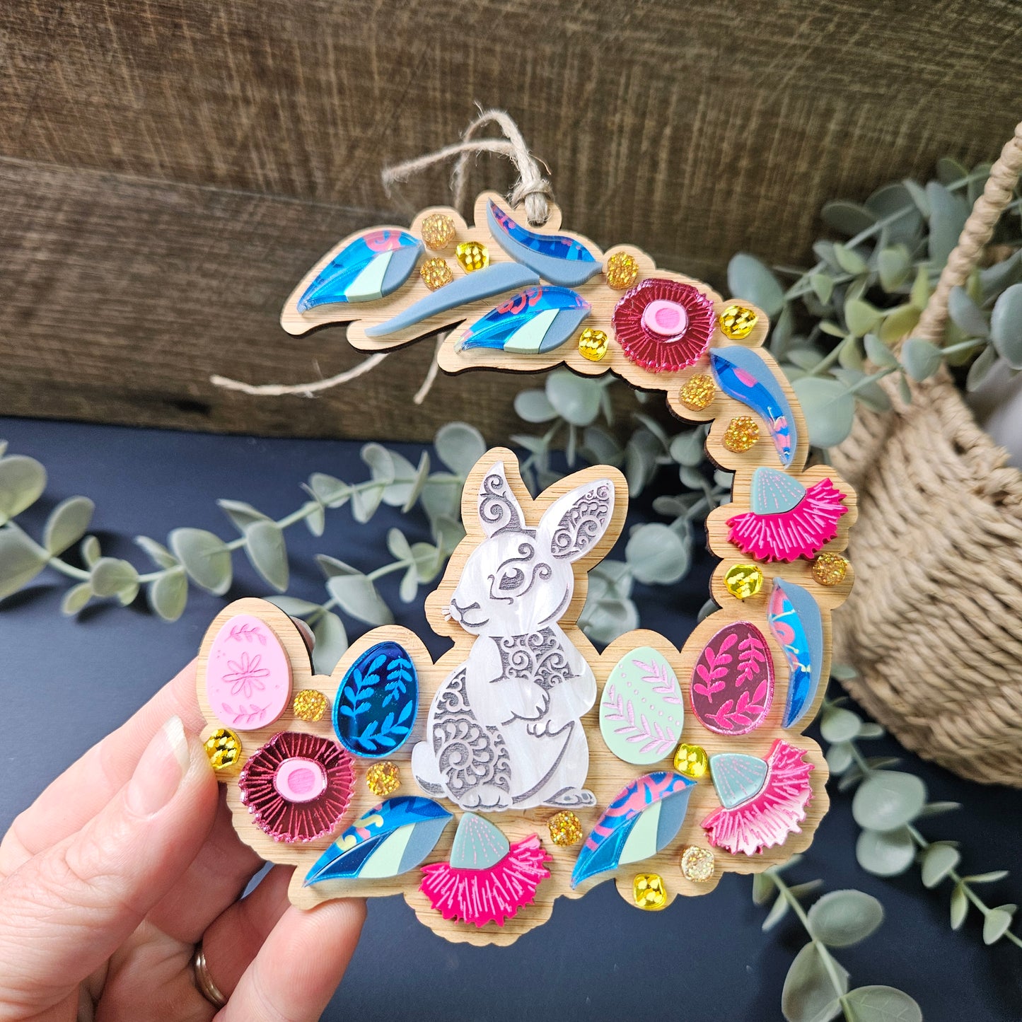 Handcrafted Easter wreath ornament featuring a cute bunny, adorned with pastel-colored eggs and Australian Native Flowers